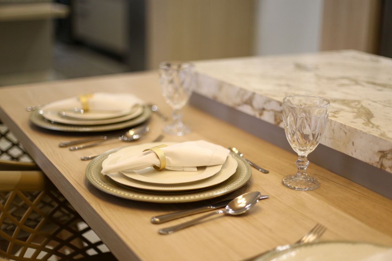 A sophisticated table setting with crystal glassware and polished crockery.