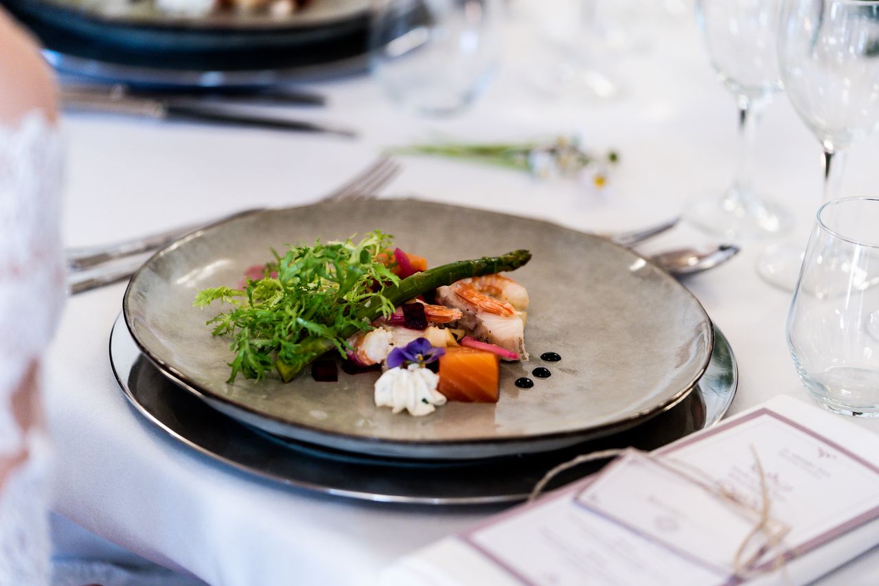 The Art of Drawing Readers In: Your attractive post title goes here A gourmet dish with vegetables and sauce elegantly presented at a sophisticated table setting.
